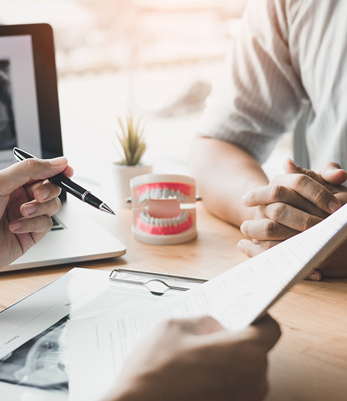 two people discussing paperwork