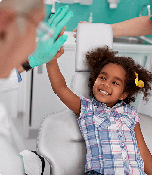 little girl high fiving dentist
