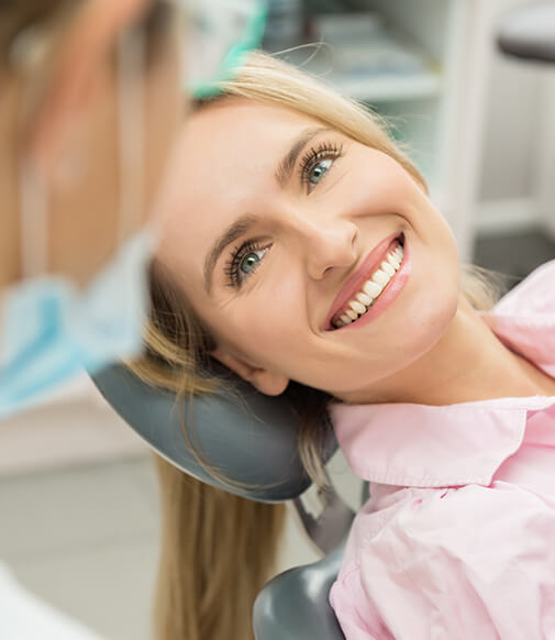 smiling woman sitting in a dental chair