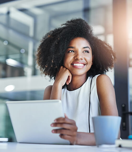 smiling woman looking at her laptop