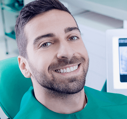 smiling man in dental chair