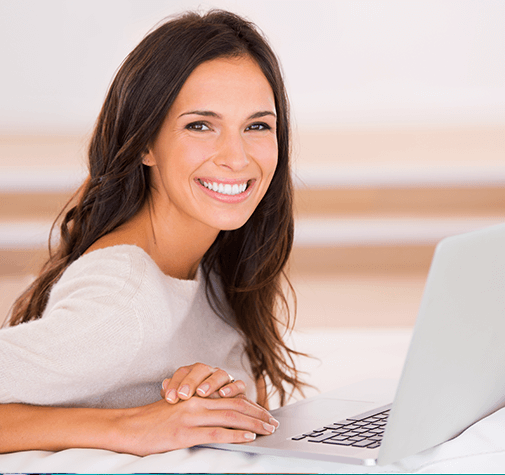 woman smiling with computer