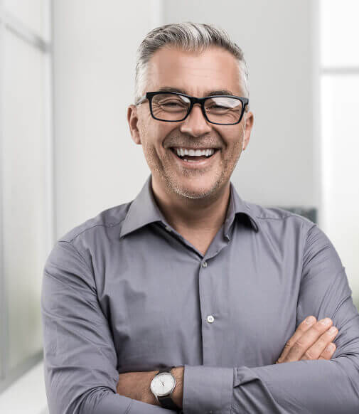 man smiling with crossed arms